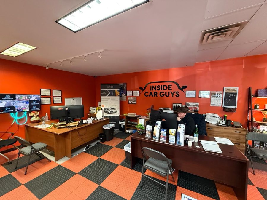 Inside Car Guys office with the logo wall, Newbury Park